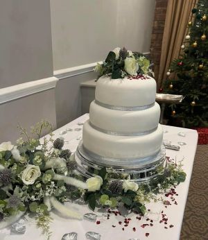 Simple tiered cake with artificial flowers
